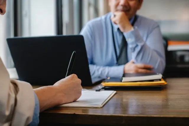 Consultants analyzing data on a screen